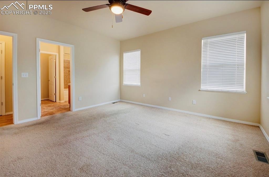 Image 22 of 42: Unfurnished bedroom with light colored carpet, connected bathroom, and a ce