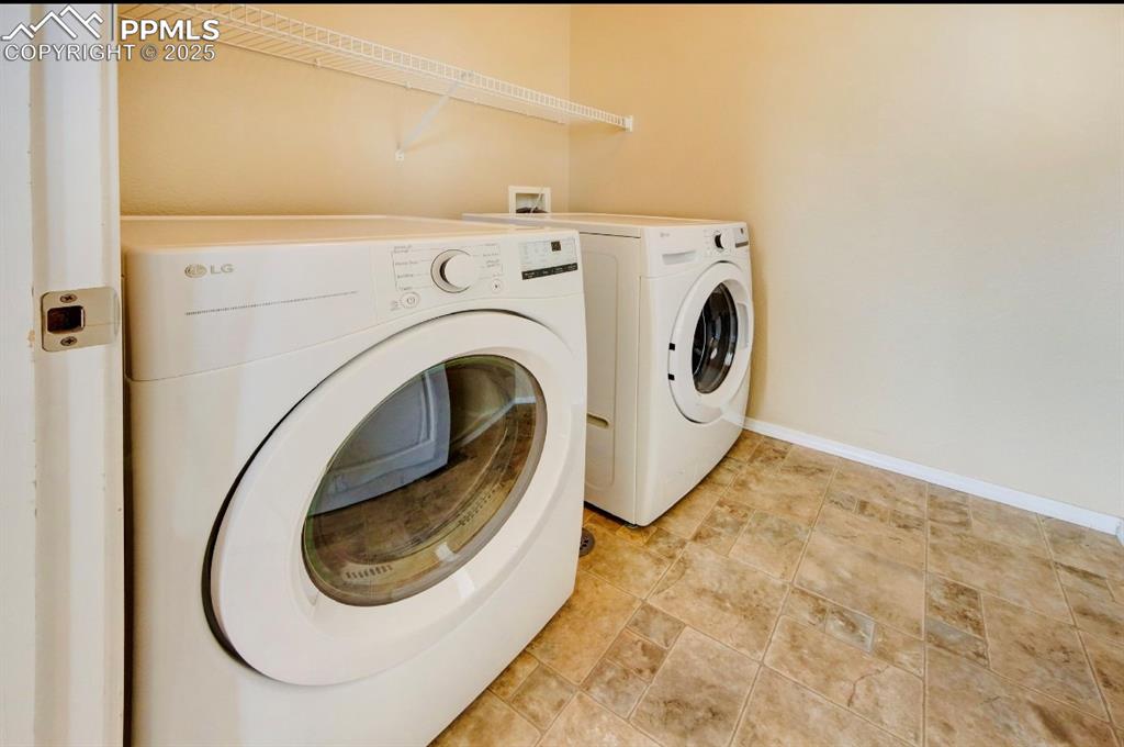 Image 25 of 42: Laundry area featuring independent washer and dryer and baseboards