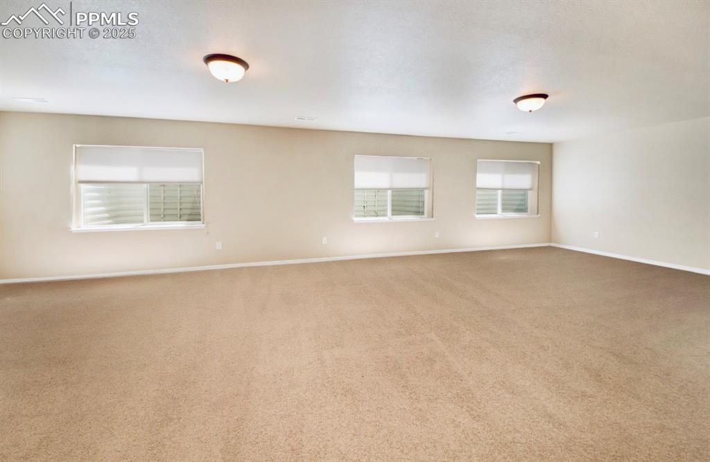 Image 33 of 42: Carpeted empty room featuring baseboards