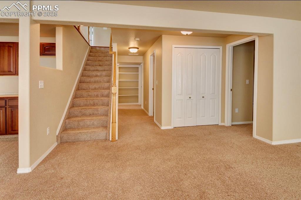 Image 34 of 42: Stairs with carpet floors and baseboards