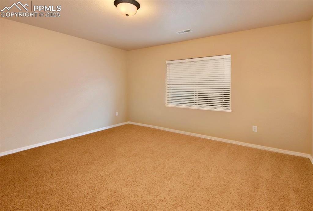 Image 36 of 42: Carpeted empty room with baseboards
