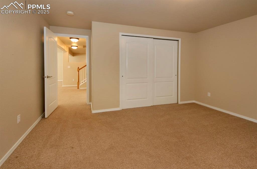 Image 38 of 42: Unfurnished bedroom with light carpet and a closet
