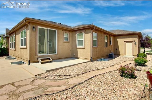 Image 40 of 42: Back of house with a patio and stucco siding