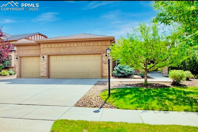 Image 42 of 42: View of front of home with an attached garage and driveway