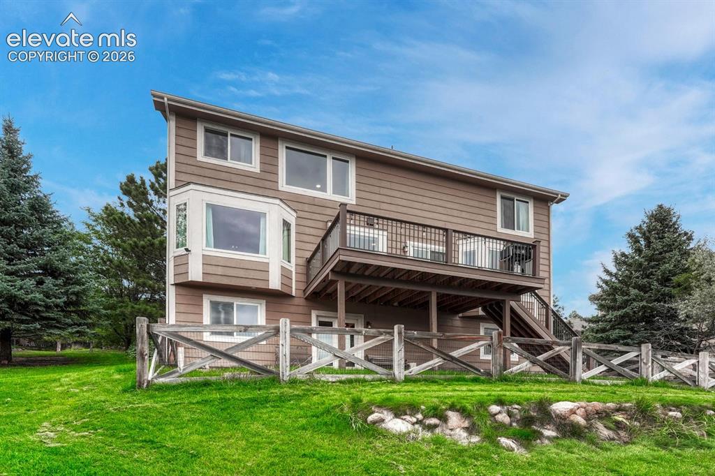 Image 34 of 41: Multi-level siding exterior with a second-story balcony