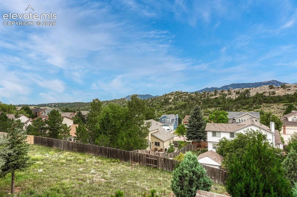 Image 36 of 41: Expansive residential area with a prominent mountain backdrop, featuring sc
