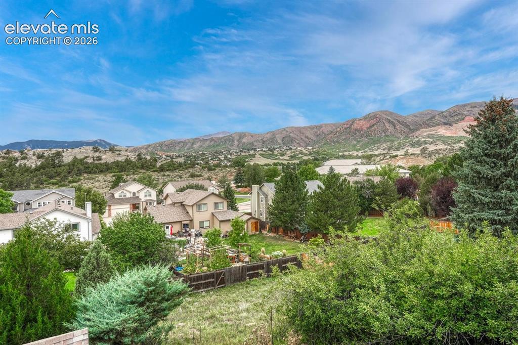 Image 37 of 41: Mountain landscape backdrop with residential properties and mature trees