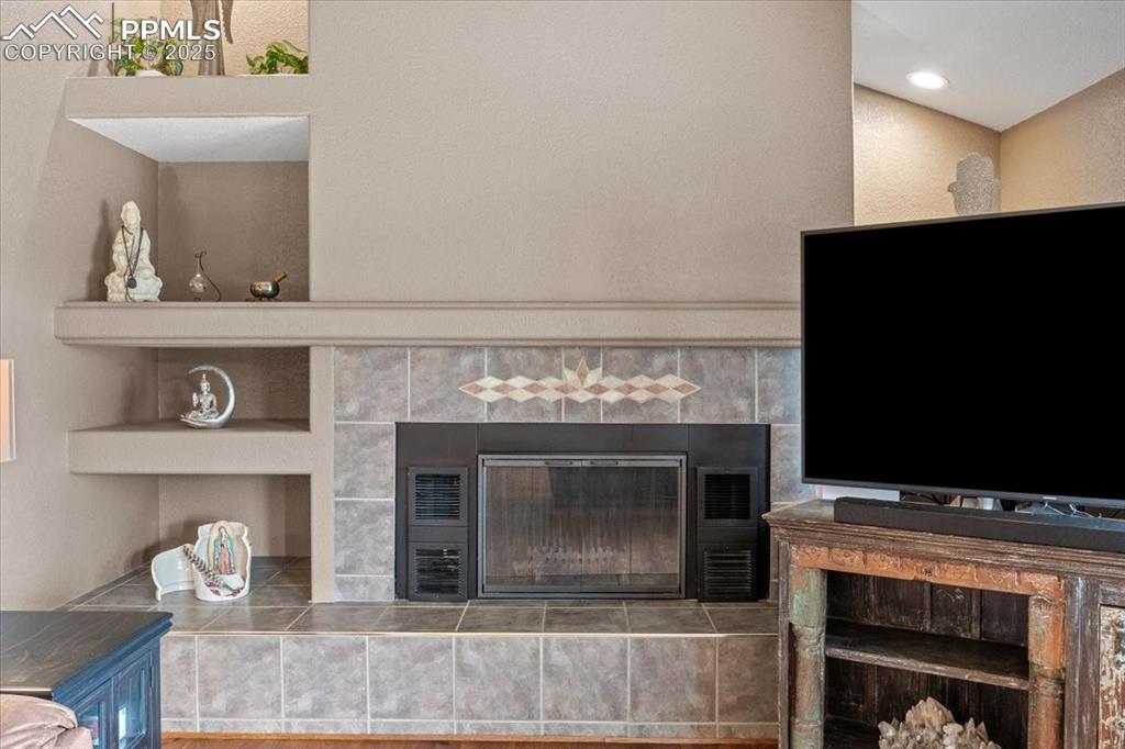 Image 15 of 49: Living room with a tile fireplace