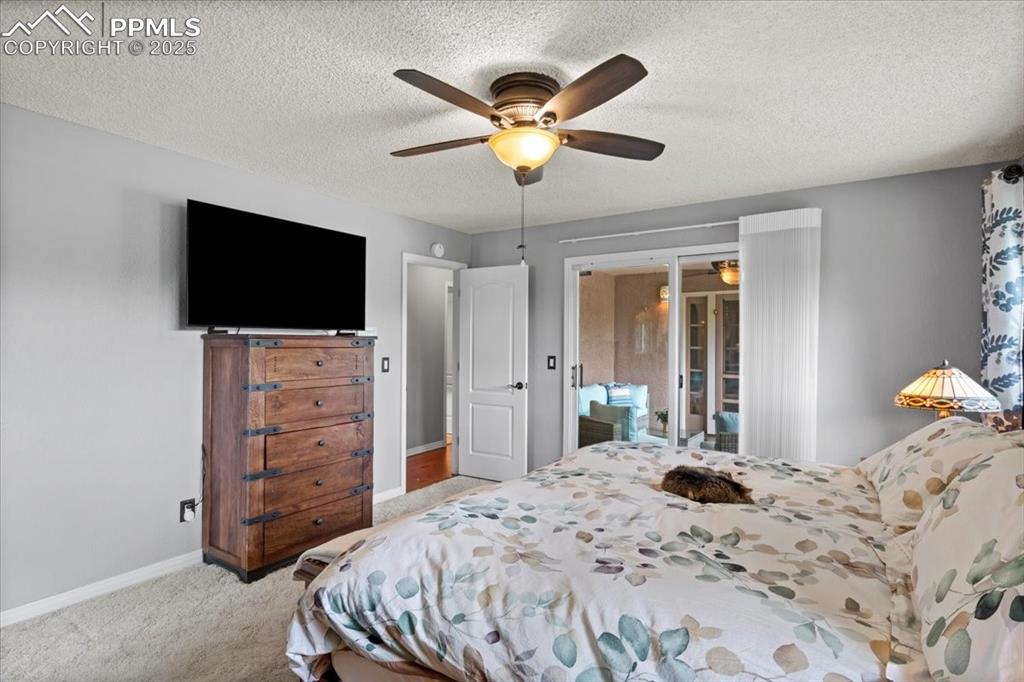 Image 17 of 49: Bedroom with baseboards, light colored carpet, a ceiling fan, and a texture