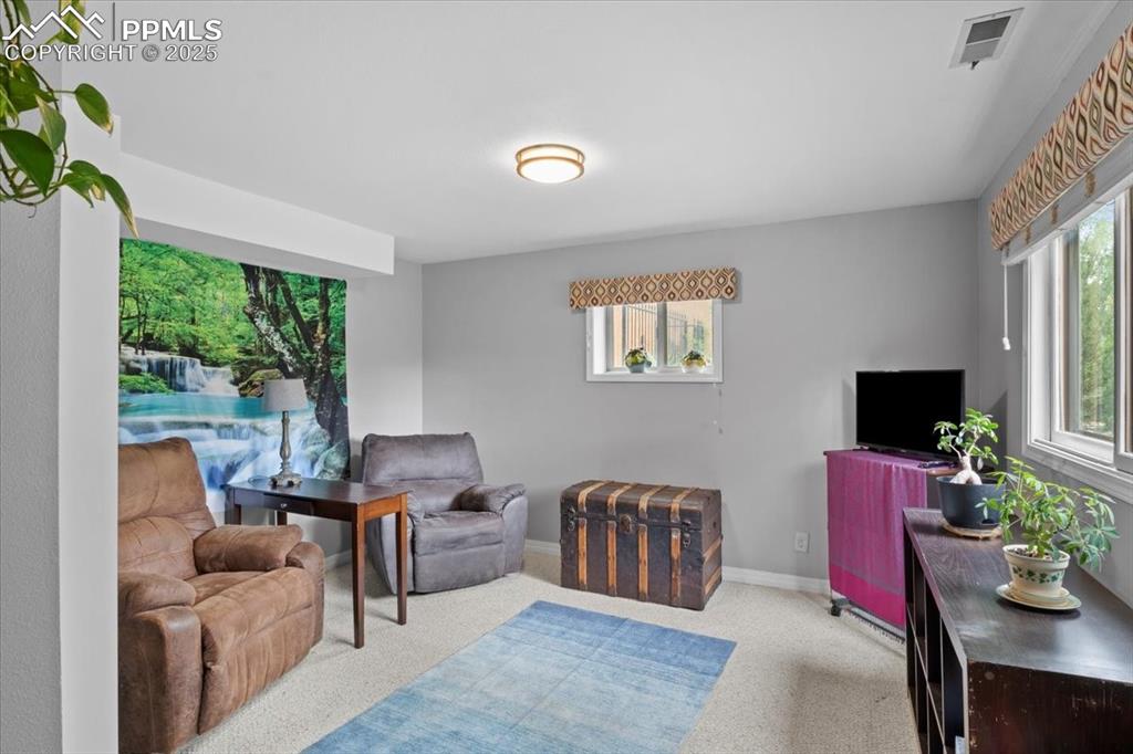 Image 33 of 49: Living area featuring baseboards