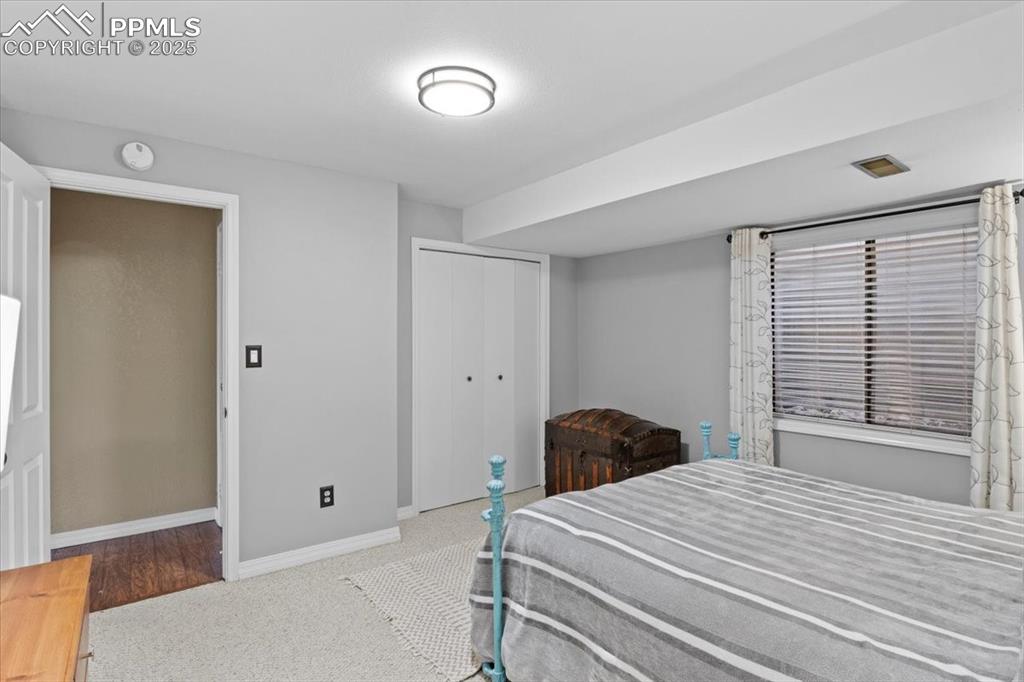Image 36 of 49: Carpeted bedroom with a closet and baseboards