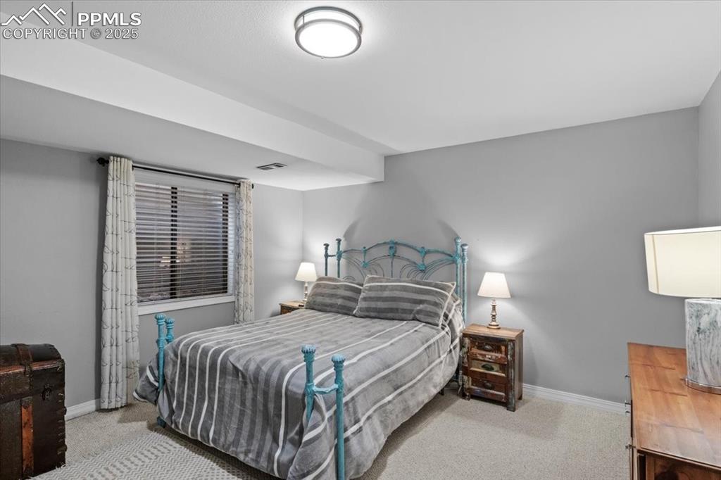 Image 37 of 49: Bedroom with carpet flooring and baseboards
