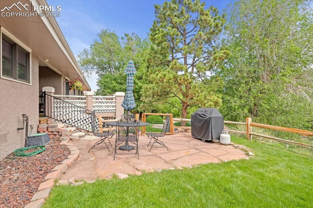 Image 42 of 49: View of yard featuring a patio area