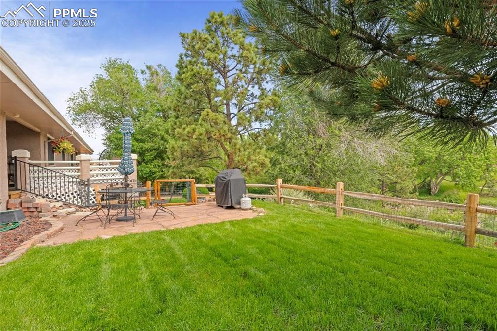Image 44 of 49: View of yard with a patio