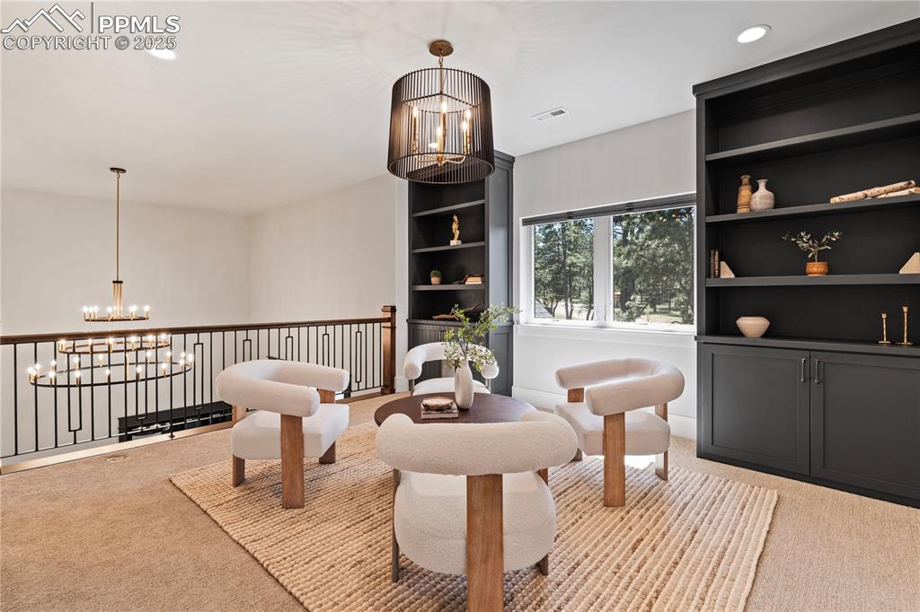 Image 27 of 49: Great room in basement overlooking the forest