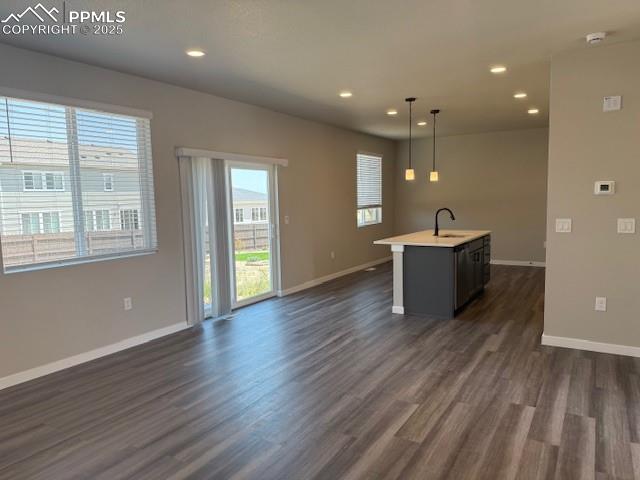 Image 8 of 8: Kitchen featuring dark wood-style floors, light countertops, recessed light