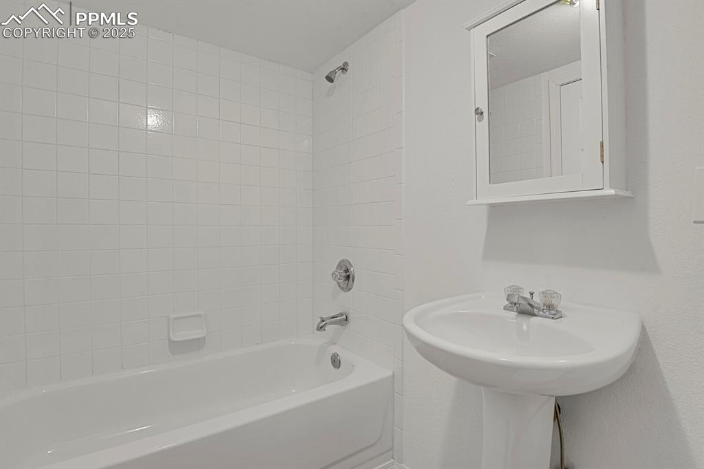 Image 21 of 27: Bathroom featuring bathing tub / shower combination