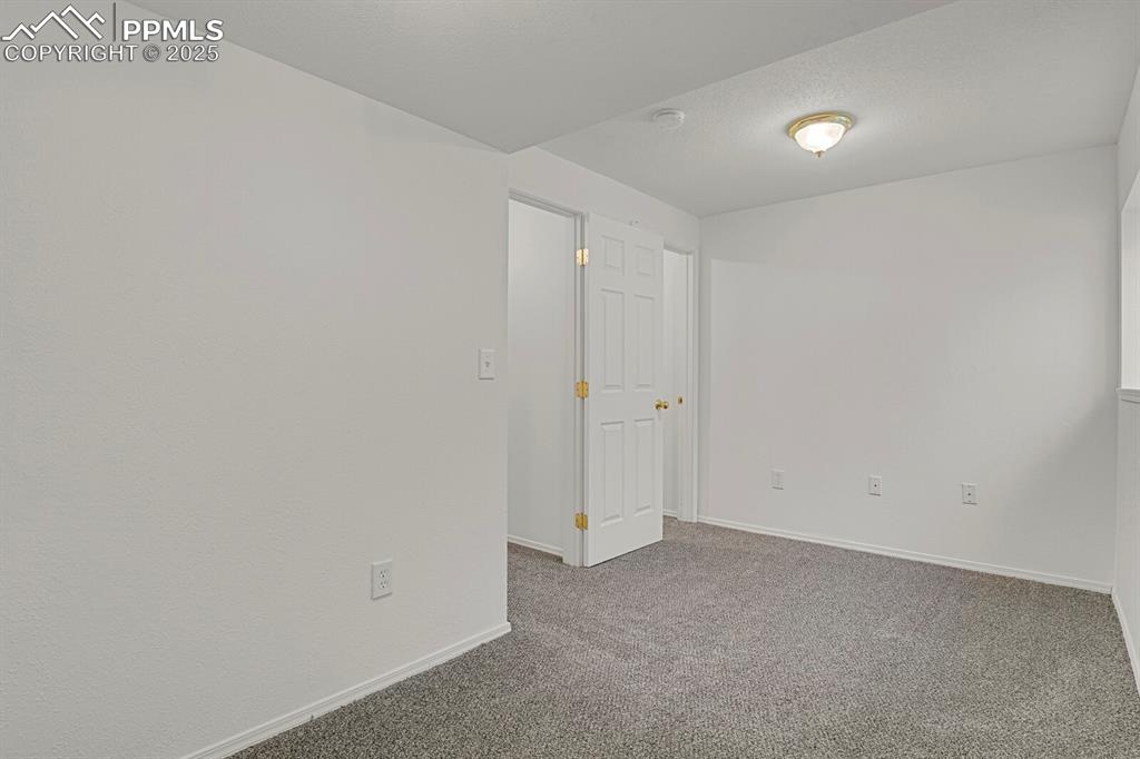 Image 23 of 27: Carpeted spare room featuring baseboards