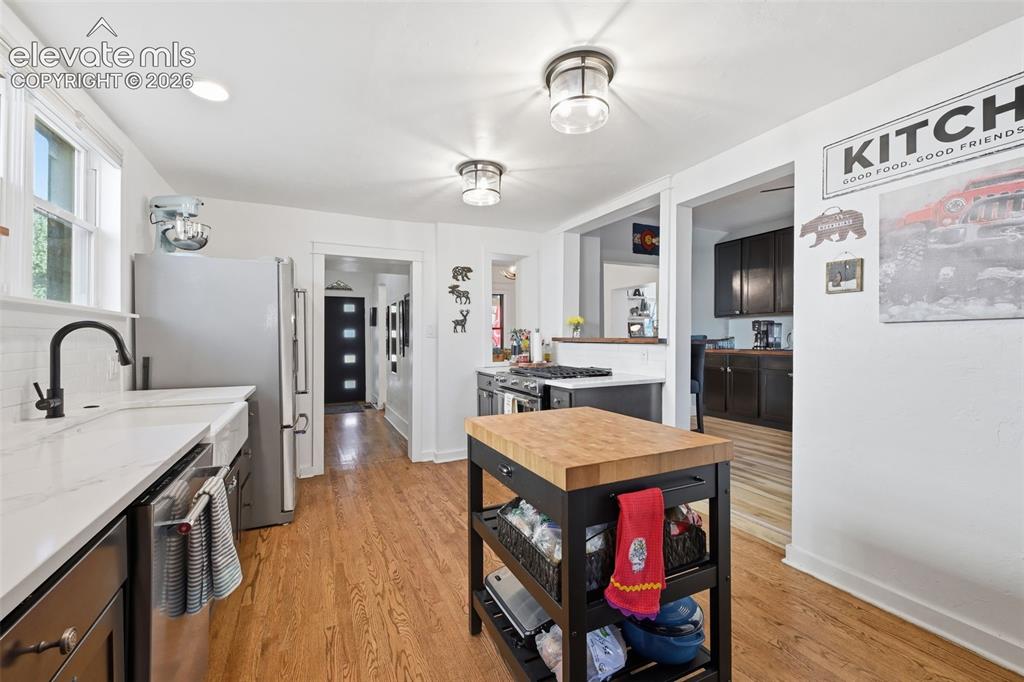 Image 13 of 50: Gas range, butcher
block island and farm
sink.