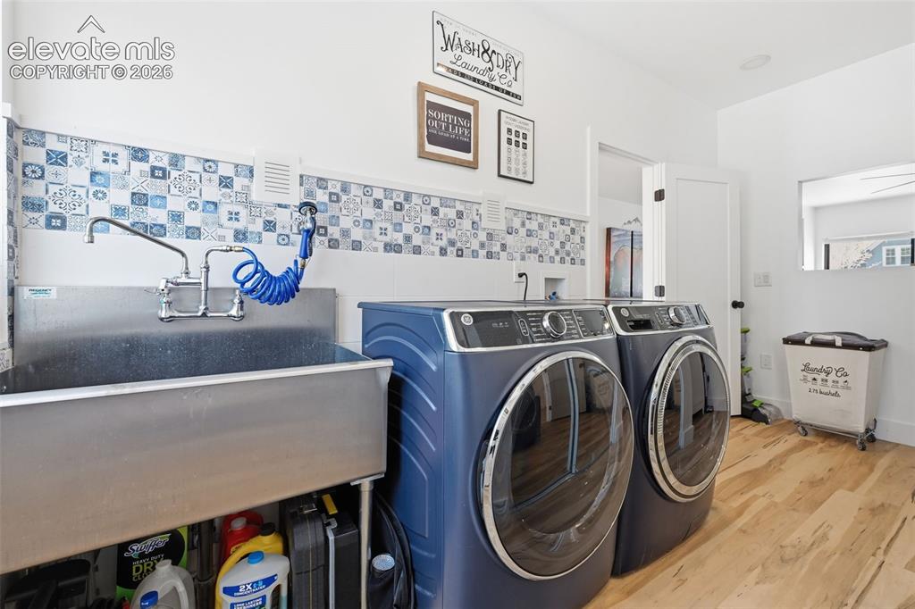 Image 17 of 50: Large utility sink,
window, and front load washer and dryer
included. Clo