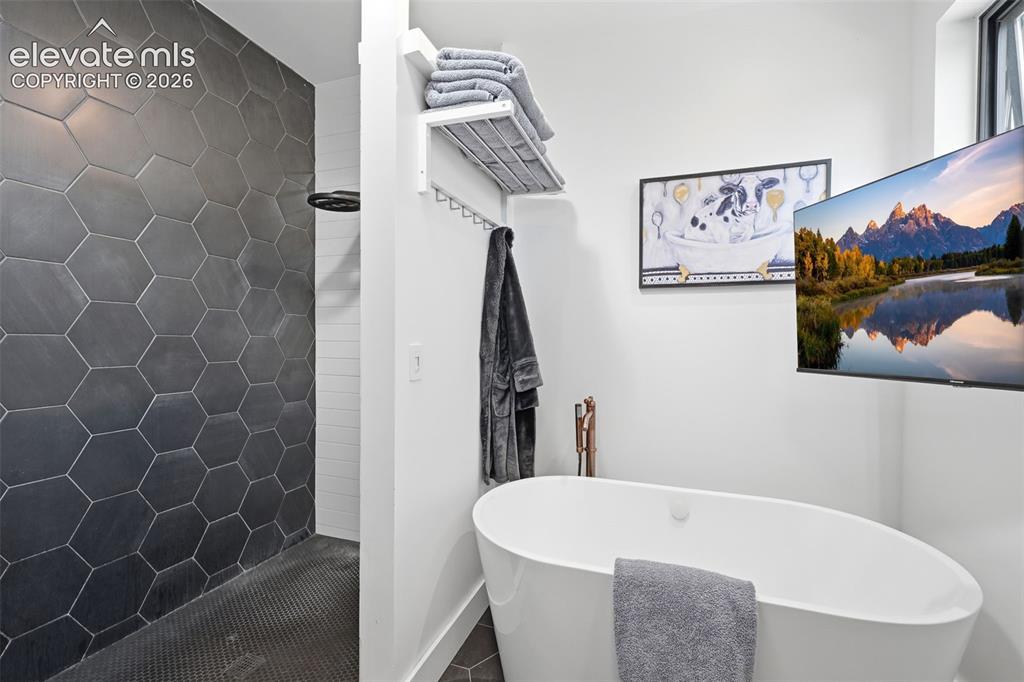 Image 20 of 50: Primary retreat Tile
surround shower and
freestanding tub
complete with