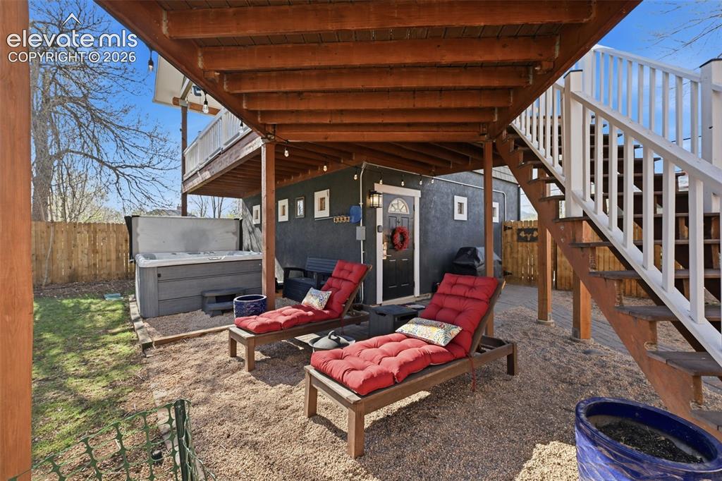 Image 43 of 50: Cottage Studio
entrance, common area hot tub and lounge
chairs.