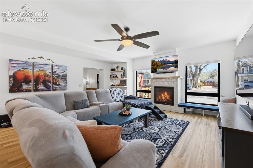 Image 9 of 50: Gas fireplace framed
with picturesque
windows.