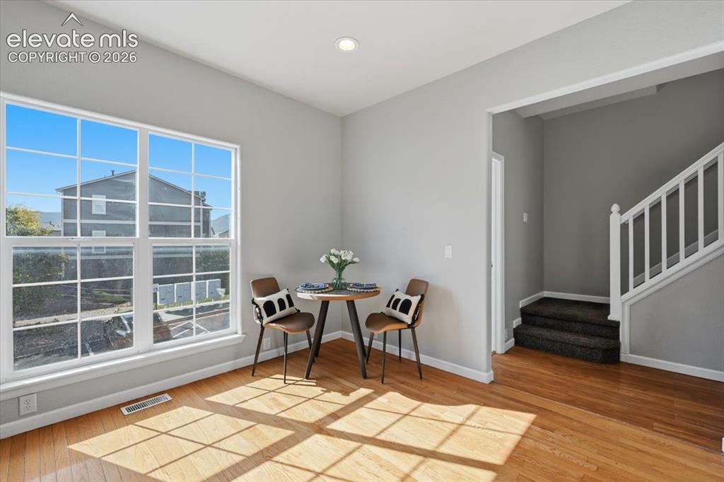 Image 15 of 34: Cozy dining or coffee space in the kitchen. Hardwood flooring throughout, b