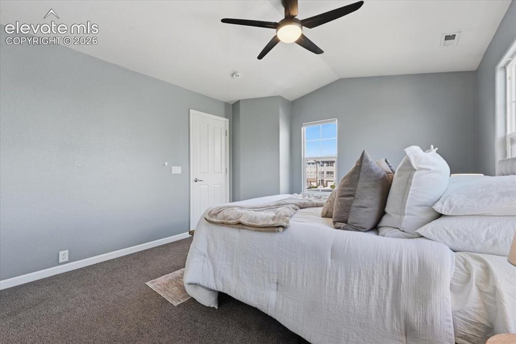 Image 17 of 34: Vaulted ceiling featuring a ceiling fan with integrated lighting, a panel d