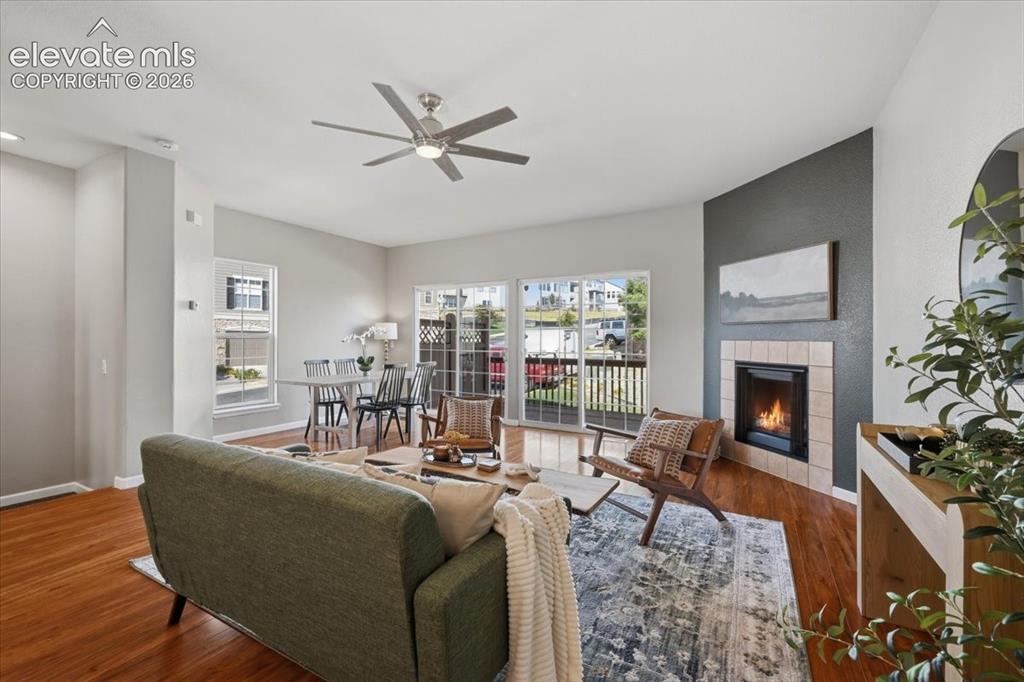 Image 2 of 34: Warm wood flooring in an open living and dining space. Room to entertain, y