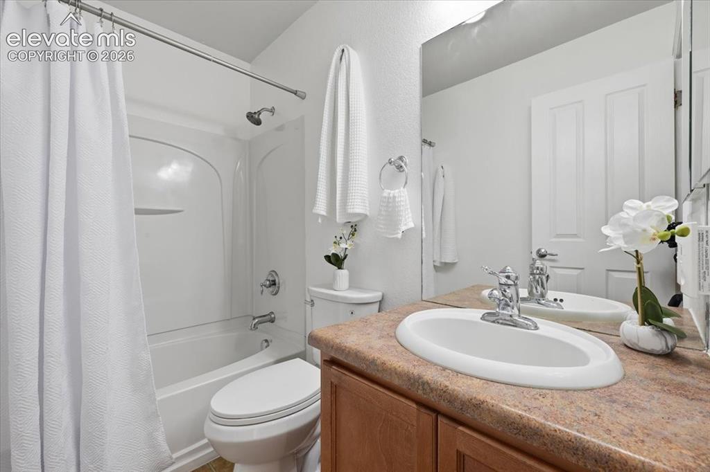 Image 23 of 34: Secondary upstairs bathroom, White bathtub with shower, integrated wall sto