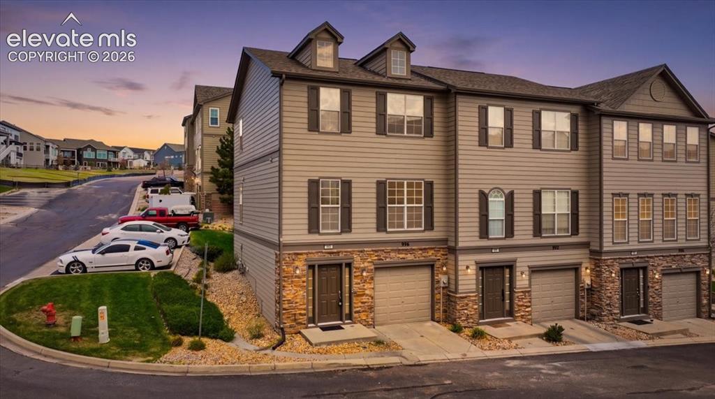Image 31 of 34: Multi-level townhome architecture featuring durable siding and stone-look a