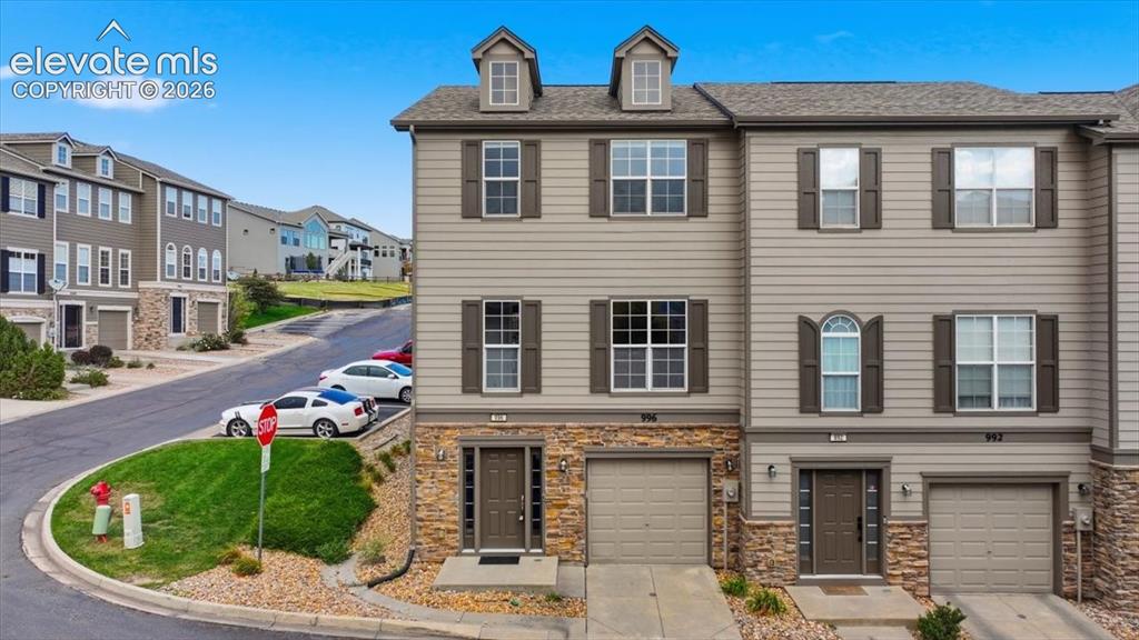 Image 6 of 34: Three story end unit townhouse with tandem 2 car garage
