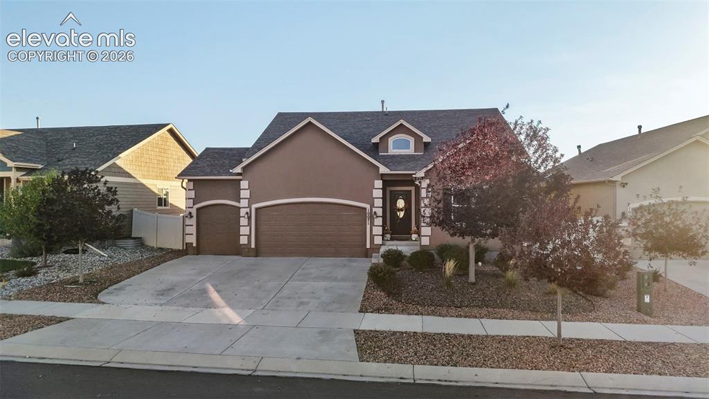 Image 1 of 47: Stucco exterior with decorative trim, two-car garage, concrete driveway, an