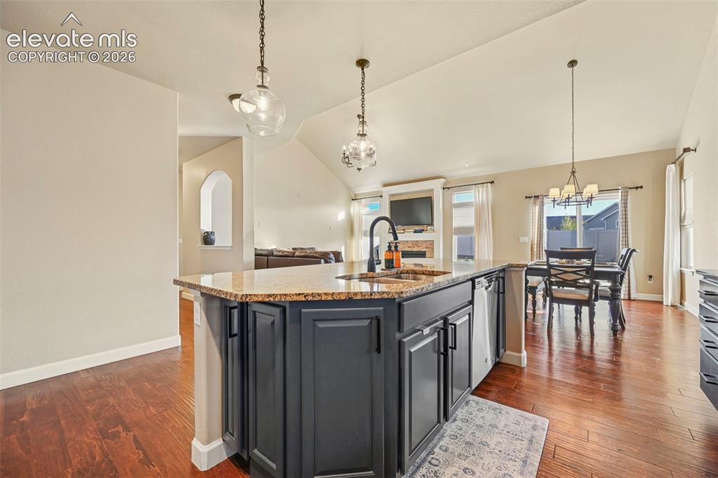 Image 10 of 47: Kitchen island featuring a single-basin sink with a matte black faucet, gra