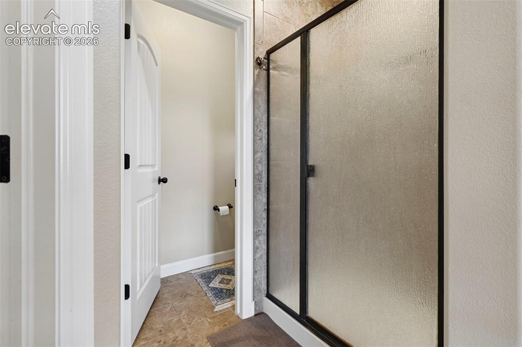 Image 19 of 47: Frosted glass shower enclosure with dark framing