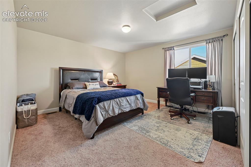 Image 27 of 47: Neutral-toned walls and carpeted flooring