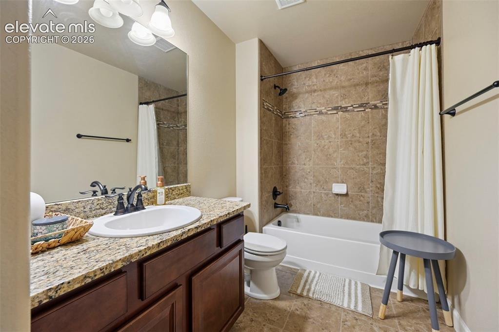 Image 29 of 47: Vanity with granite-style countertop, undermount sink, and dark wood-finish