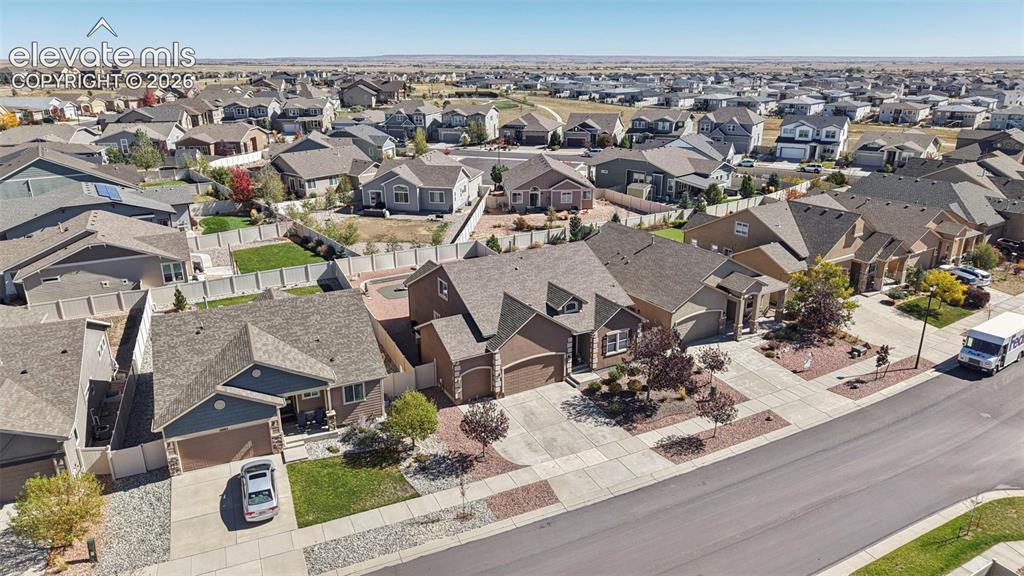 Image 3 of 46: Aerial perspective of a suburban neighborhood featuring paved streets, conc