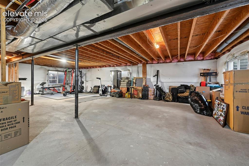 Image 30 of 47: Expansive unfinished lower level featuring exposed joists, concrete floorin