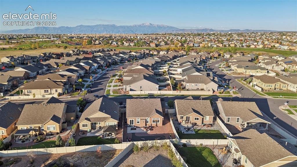 Image 39 of 47: Residential neighborhood with extensive housing, paved streets, and distant