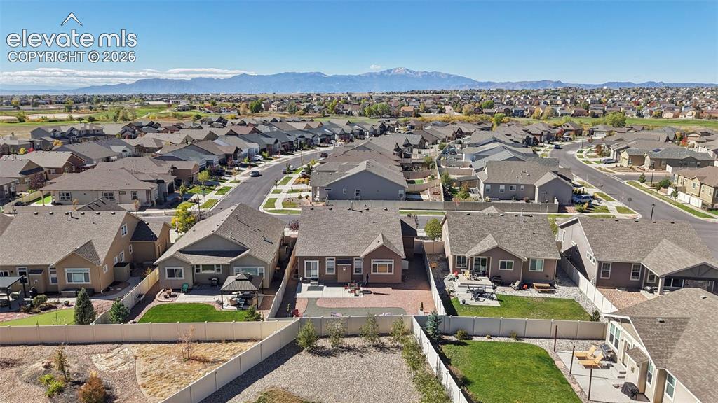 Image 39 of 46: Aerial perspective featuring a paver patio and residential setting with a m