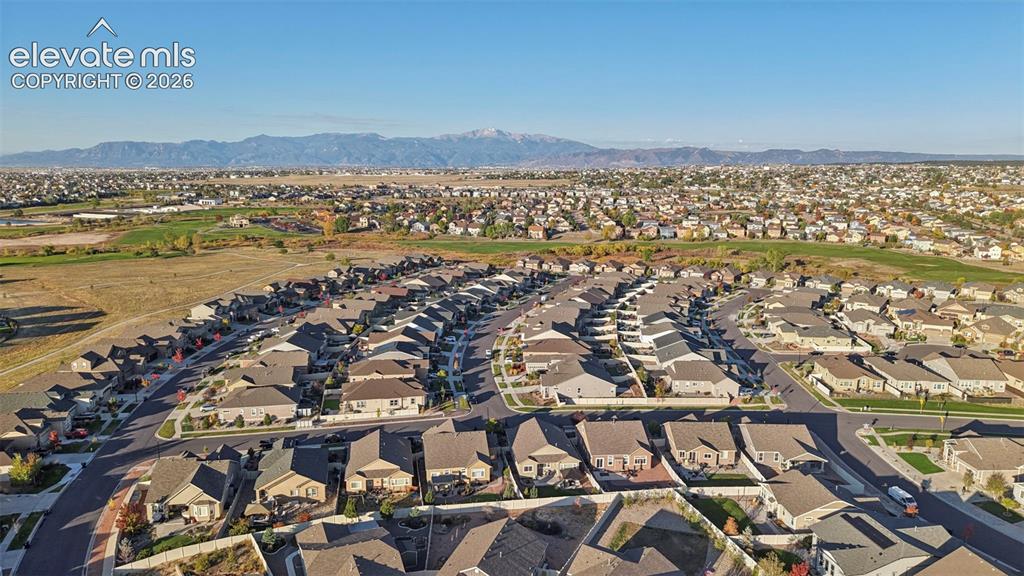 Image 40 of 47: Expansive residential area with multiple single-family homes, clear mountai