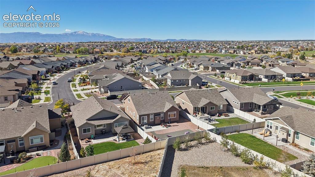 Image 40 of 46: Aerial perspective of residential neighborhood featuring fenced backyards,