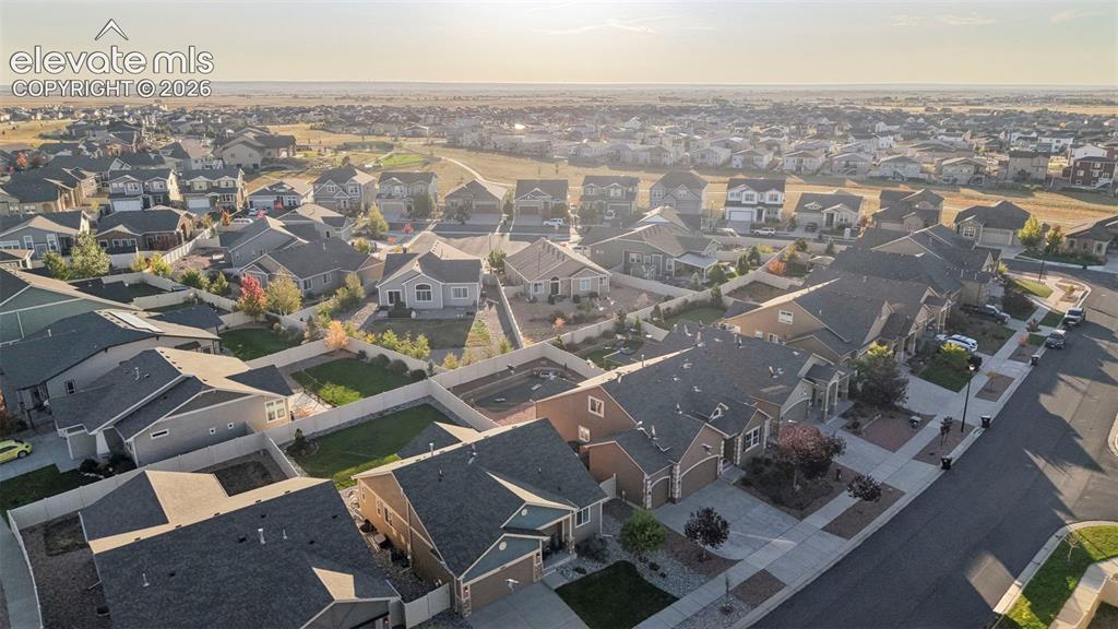 Image 43 of 47: Expansive residential area featuring numerous single-family homes with pitc