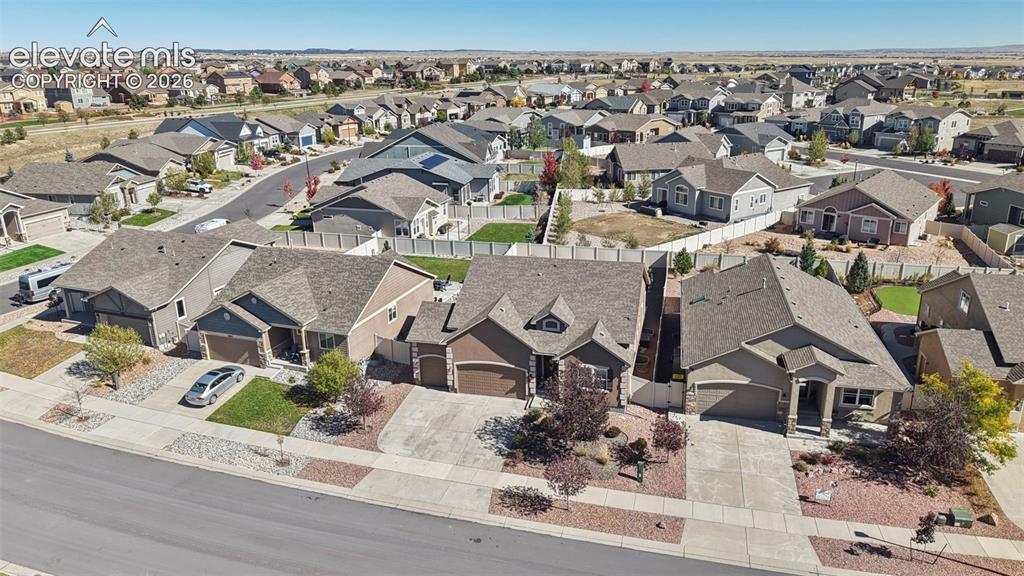 Image 45 of 46: Aerial perspective of a suburban neighborhood featuring paved streets, asph