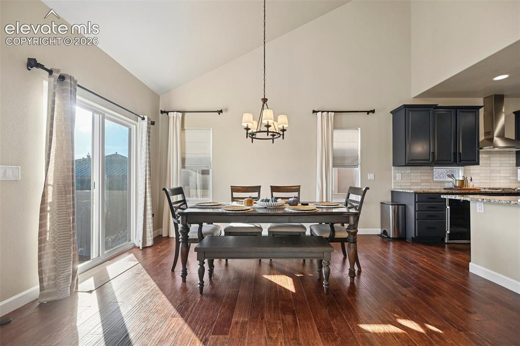 Image 9 of 47: Vaulted ceilings, wood-finish flooring, sliding glass door, recessed lighti
