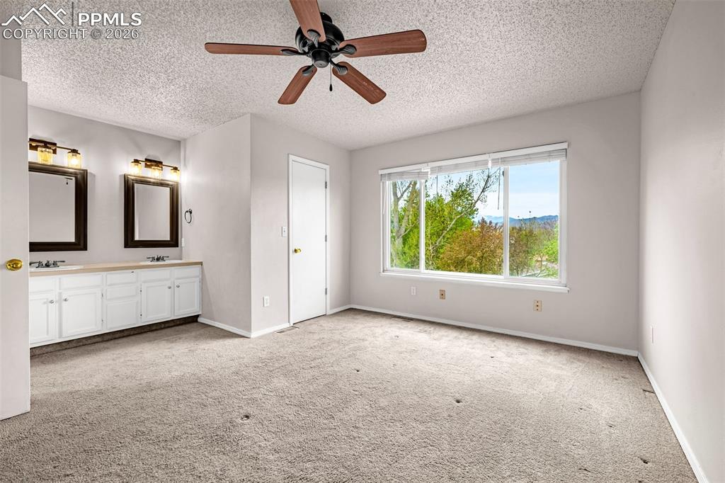 Image 12 of 41: Room featuring a double vanity with white cabinetry, dual framed mirrors, a