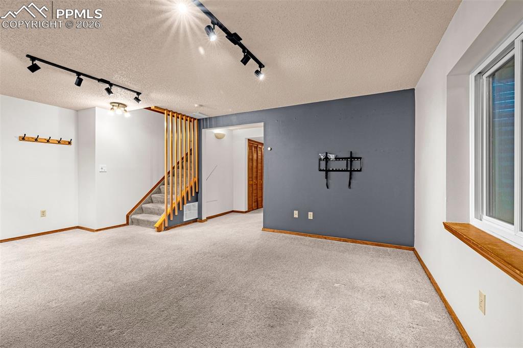 Image 21 of 41: Finished room featuring light-colored carpeting and white walls