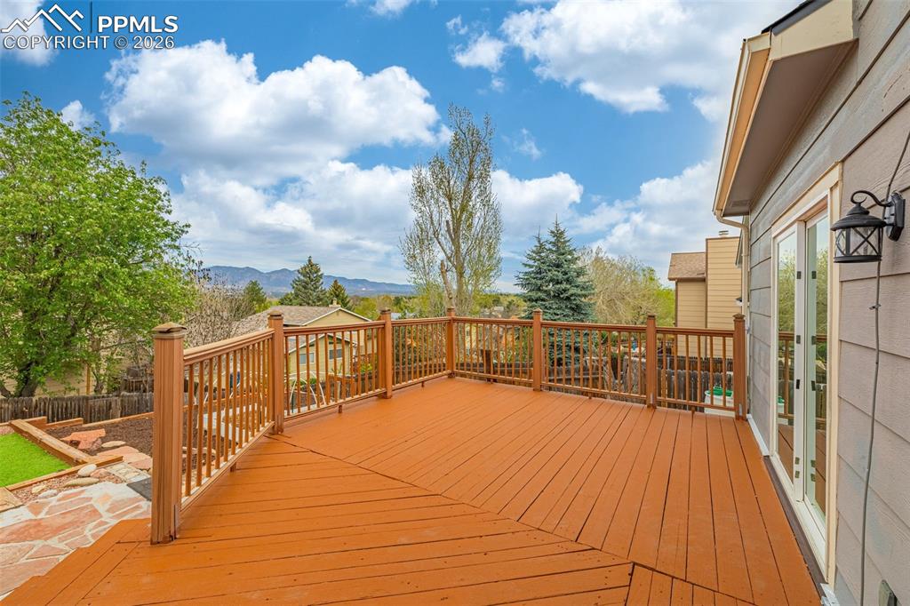Image 26 of 41: Spacious outdoor deck featuring wood-finish decking and railing
